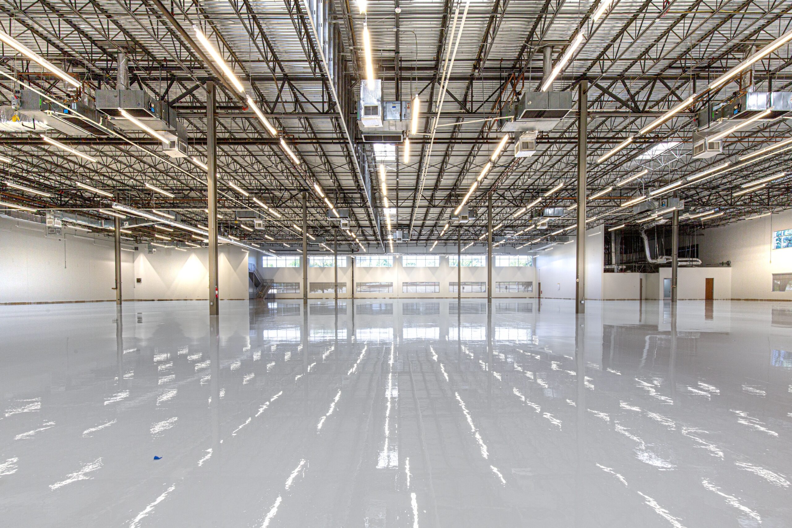 Large industrial warehouse with glossy commercial resin flooring