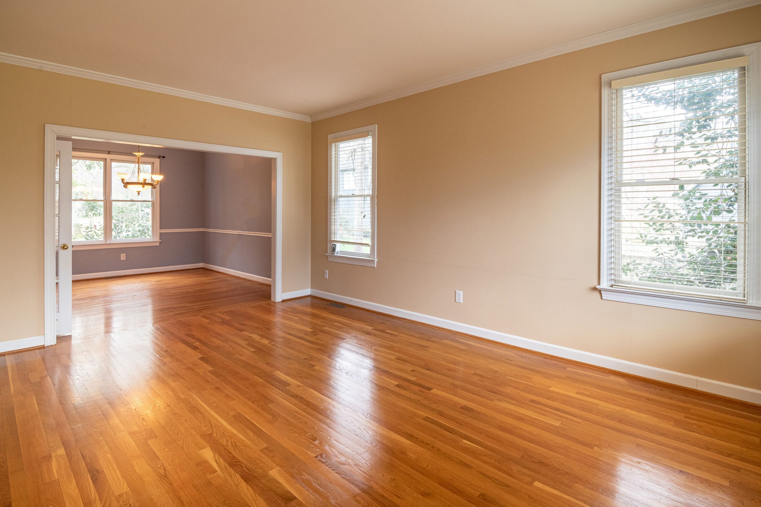 Empty room with glossy hardwood flooring